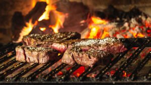 What is the difference between grilling and barbecuing