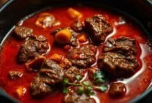 Create a closeup vibrant image of Stewing beef in a Pot